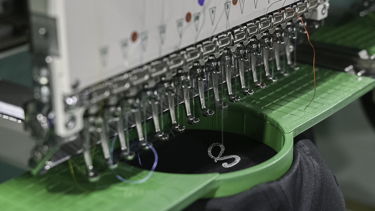 an embroidery machine embroidering the letter 's'