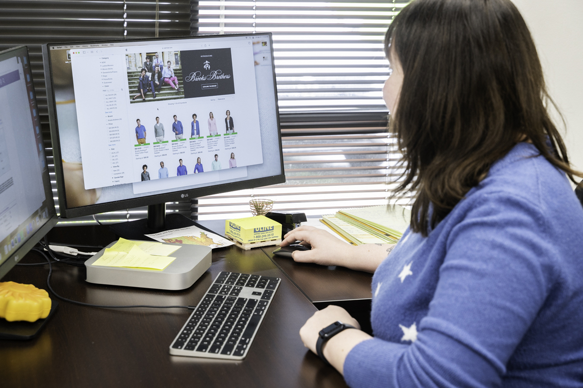 a woman looking at different clothing options on a computer screen